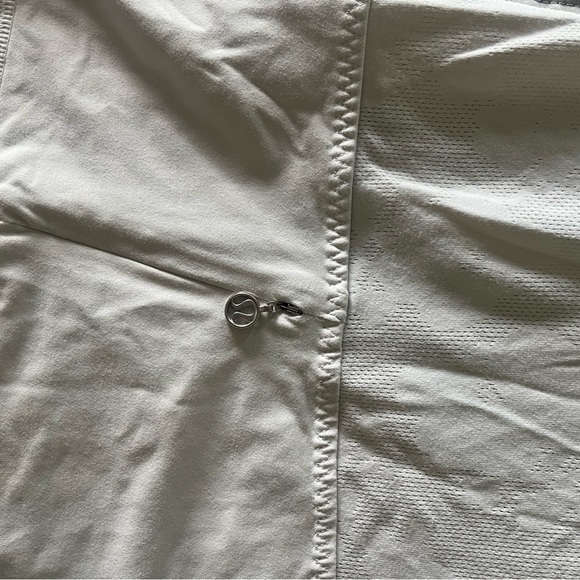 Lululemon white athletic top with detailing and pocket in the back. - Picture 3 of 4